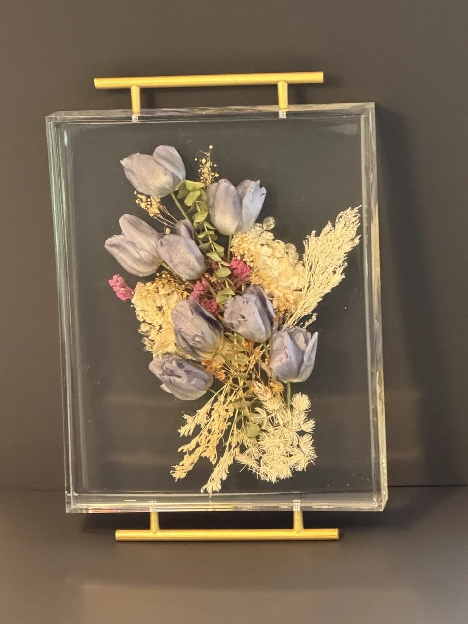 Full view of a clear resin wedding-flower tray with gold handles
