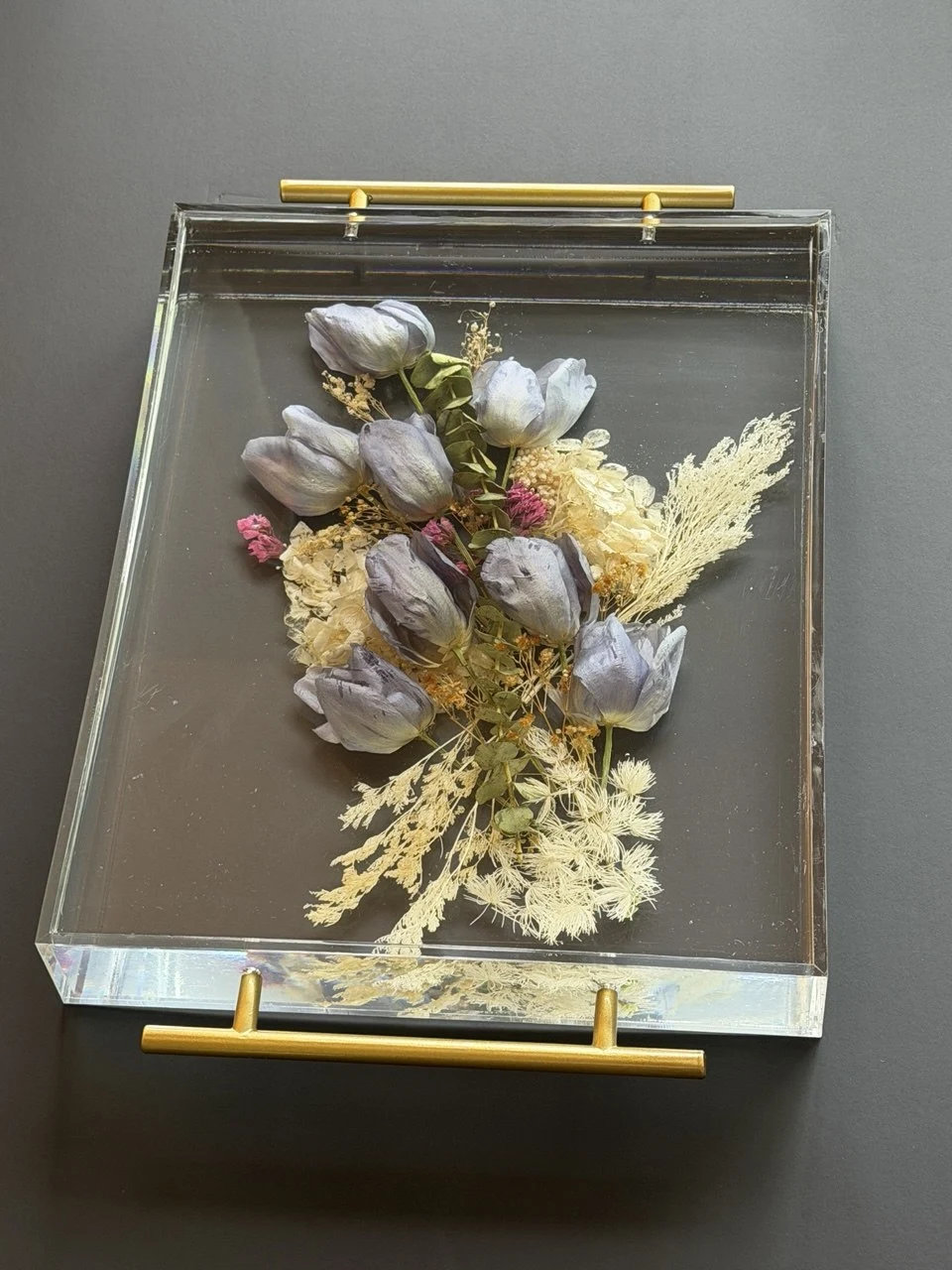Front angled view of a clear resin wedding-flower tray