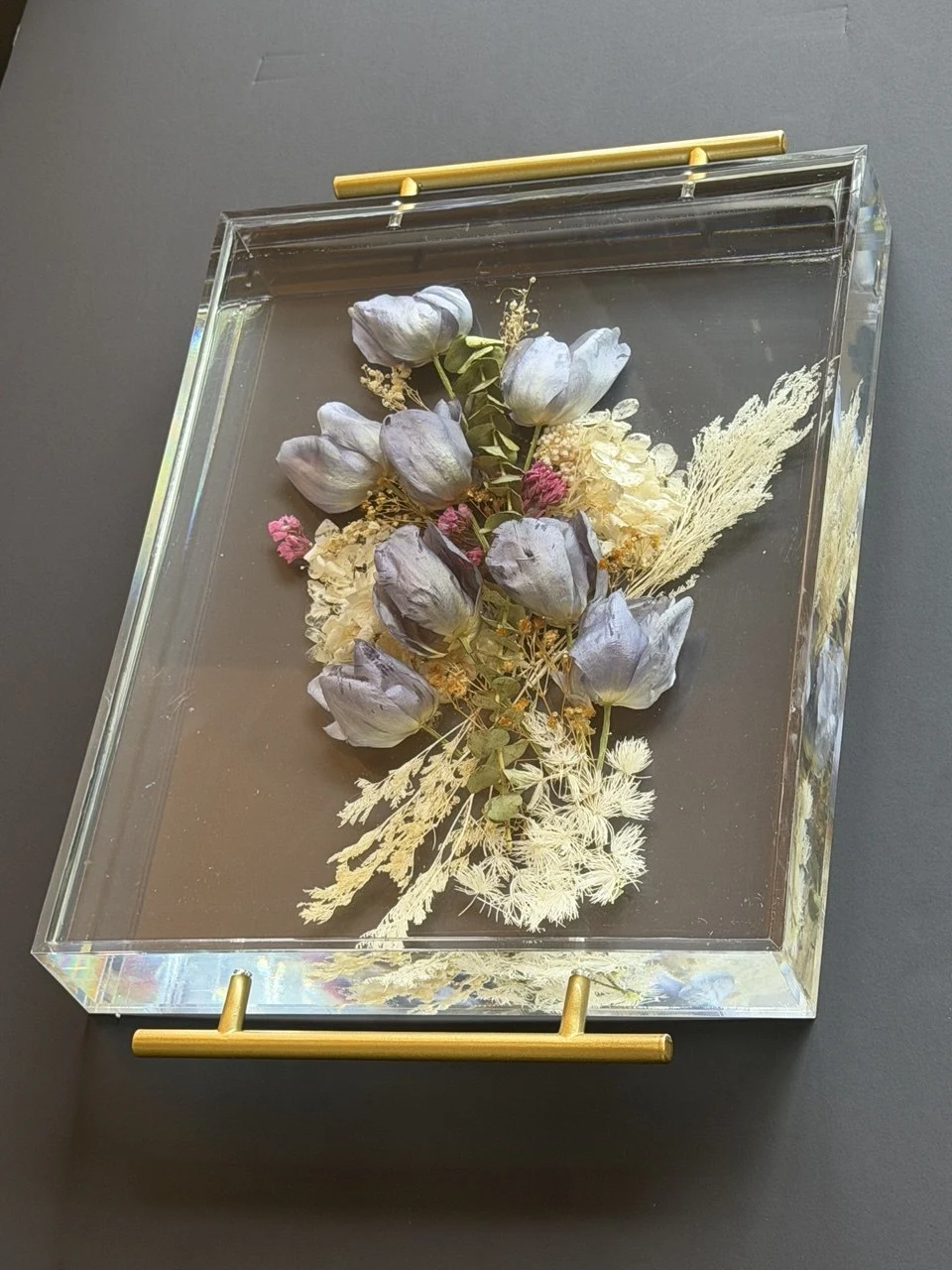 Side angled view of a clear resin wedding-flower tray